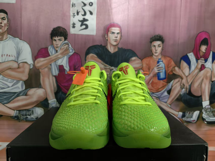 Front view of vivid green Nike Kobe basketball shoes with textured uppers and neon laces