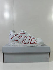 Side profile of the white low-top sneaker with red-outlined AIR lettering and a white platform-style sole.