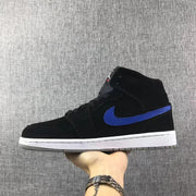 Side view showing the black Jordan 1 Mid upper with a blue Swoosh and white midsole.
