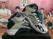 Angled view of the pair highlighting the patterned collar, grey upper, black overlays and basketball graphic.