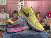 Angled view of the mismatched pair, showing the yellow shoe over the gray and purple-pink shoe with contrasting Swoosh details.
