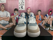 Front view of white, blue, and grey Air Jordan 4 sneakers