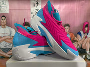 Angled view of the pink and blue sneakers showing the layered upper and sculpted outsole.