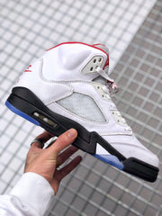 Side view highlighting the white layered upper, perforated side panel, black midsole, visible air unit, and blue outsole.