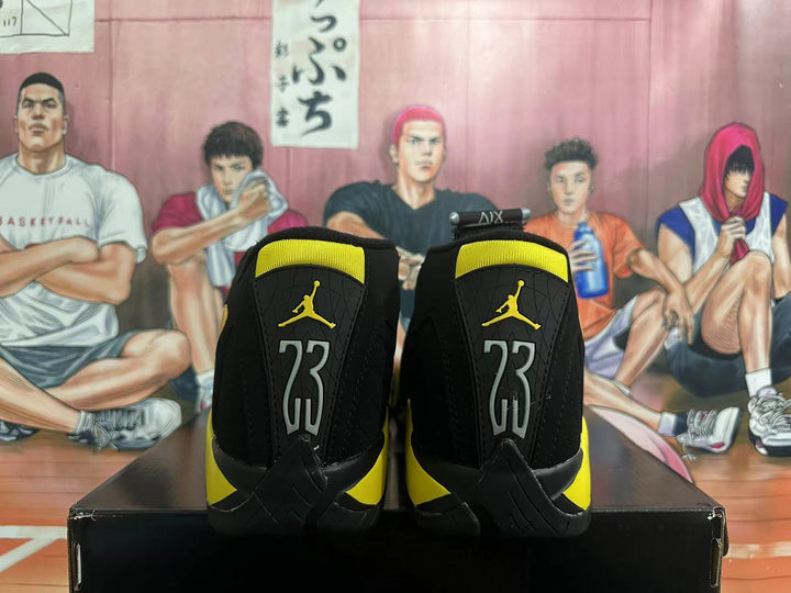 Rear view of black and yellow Jordan high-top sneakers with heel number 23