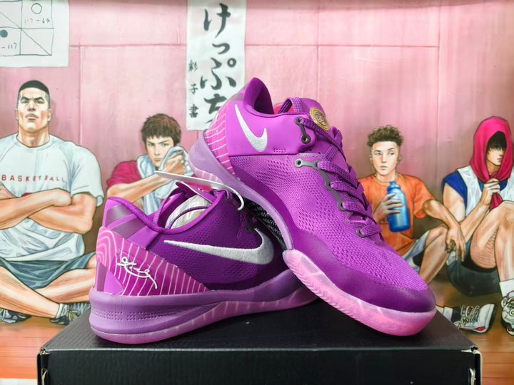 Purple Nike basketball sneakers shown from an angled side view, with white Swoosh details and patterned heel panels.