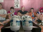 Rear view showing the blue heel panels, white heel straps, and white rubber soles.