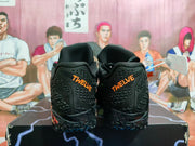 Rear view showing orange TWELVE embroidery on the black shoe heels.