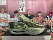Side profile of a green Nike basketball sneaker showing the layered upper, lime-green Swoosh, ribbed side detail, and sculpted outsole.