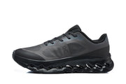 Side view of a charcoal On Cloudtilt Remix sneaker with a sculpted cutout sole.