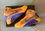 Angled top view of the gold-yellow and purple basketball shoes