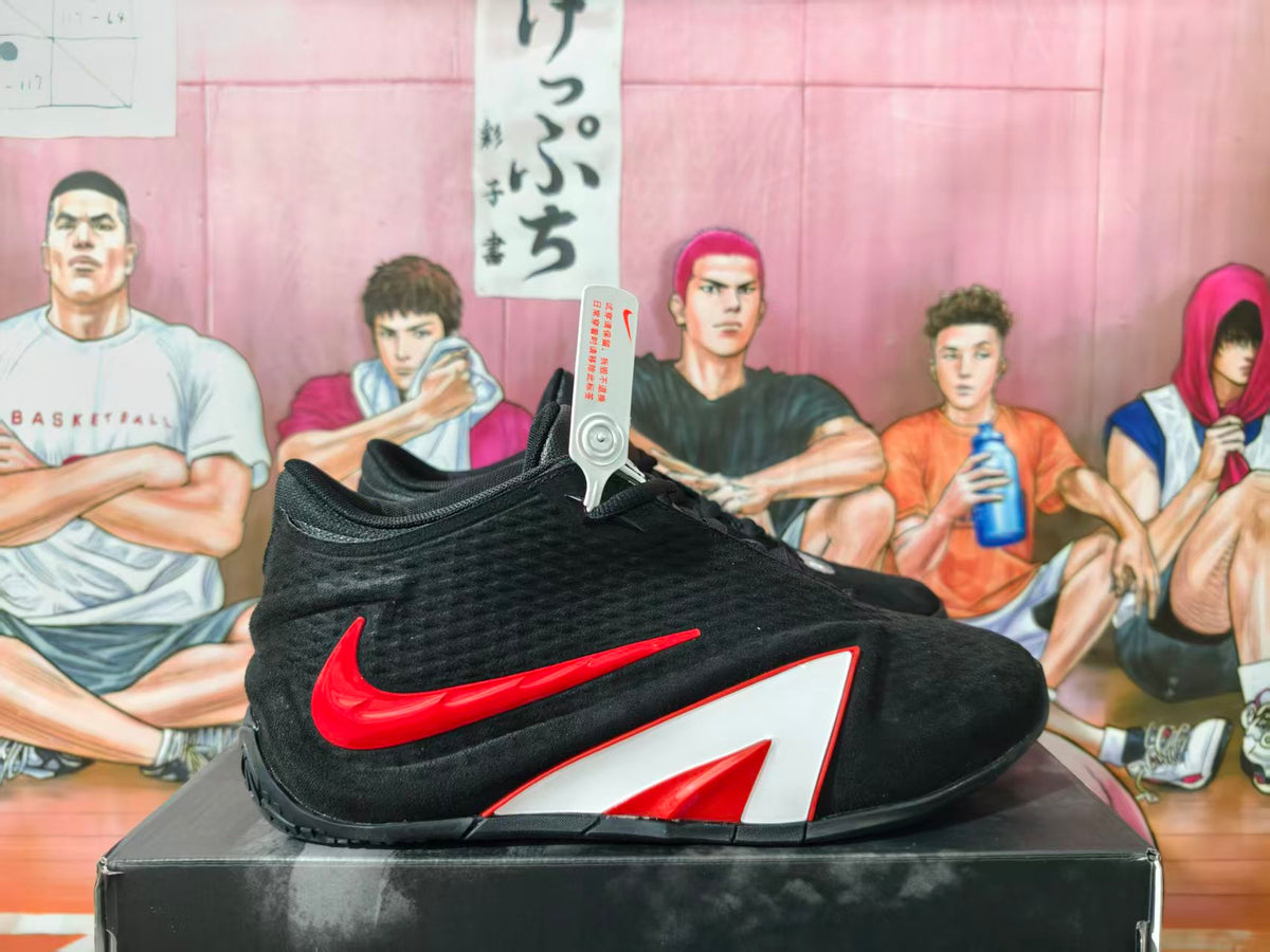 Side view of a black Nike basketball shoe with red Swoosh and white-and-red side panel.