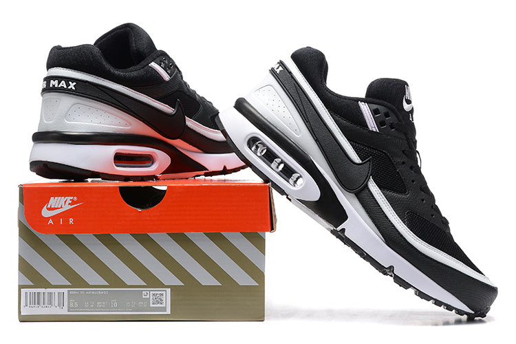 Black and white Nike Air Max sneakers displayed on a branded box, with side and heel views.