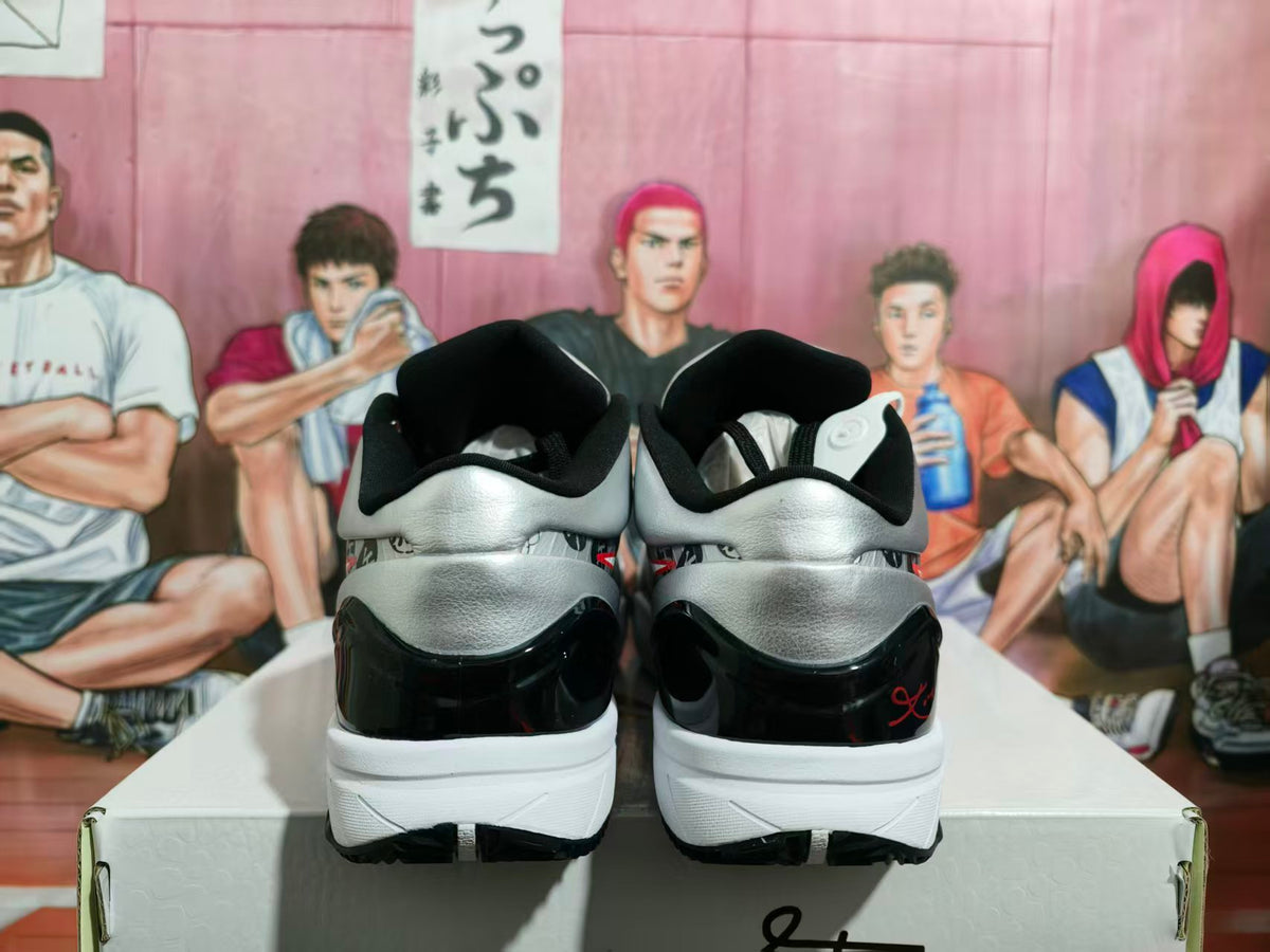 Rear view of silver-gray and black Nike basketball sneakers on a white shoe box.