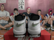Rear view of black and white Nike high-top sneakers showing the heel branding details and visible Air units.