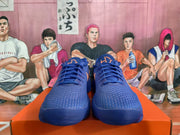 Front view of blue Nike sneakers with orange tongue details, blue laces, and textured uppers.