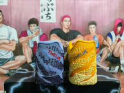Rear view of the blue and yellow shoes, with “TWELVE” lettering visible on both heels.