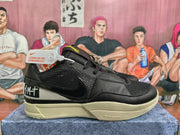 Side profile of a black Nike sneaker showing the swoosh, textured upper, layered panels, and cream-colored sole.