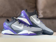 Pair of gray, black, purple, and white basketball shoes shown in profile.