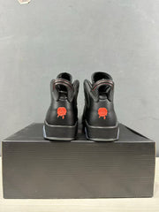 Rear view showing the padded collars and red heel graphics on the black sneakers.