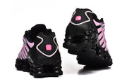 Rear and outsole views of black and pink Nike Shox TL sneakers.