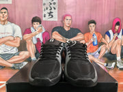 Front view of black and grey Nike basketball sneakers showing the black laces, textured toe boxes, grey overlays, and tongue details.