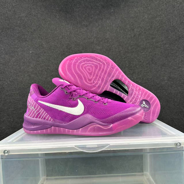 Pair of purple Nike basketball sneakers shown from the side, including the translucent outsole.