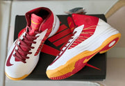 Pair of red and white high-top basketball shoes shown from above and at an angle on a black shoebox.
