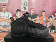 Side profile showing the sculpted black upper and textured outsole of a high-top sneaker.
