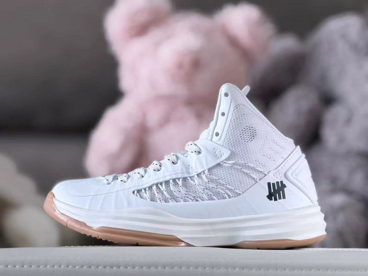 White high-top Nike HD2012 kids' basketball shoe with mesh panels and gum outsole