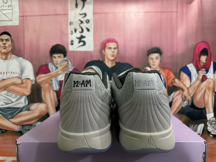 Rear view of grey Nike basketball shoes showing MAMBA heel tabs and patterned upper details.
