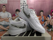 Angled view of a pair of white Nike sneakers with patterned Swoosh details and “CHAPTER ONE” heel tabs.
