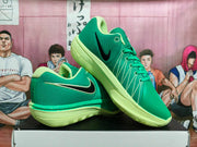 Angled view of green Nike basketball shoes with black Swoosh details and lime-colored soles.