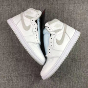 Pair of white and grey high-top sneakers arranged side by side.
