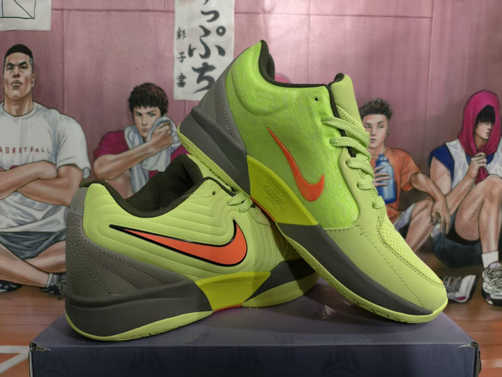Pair of yellow-green Nike basketball sneakers displayed from the side, with orange branding, dark gray heel panels, and black accents.