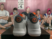 Rear view of the sneakers showing Nike and KD heel logos, grey uppers and textured soles.