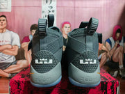 Rear view of grey Nike shoes showing heel logos and pull tabs.