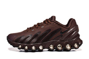 Side profile of brown Nike Air Max DN8 sneakers showing layered overlays and sculpted sole details.