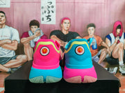 Rear view showing contrasting blue and pink heel sections with circular McDonald's-themed badges.