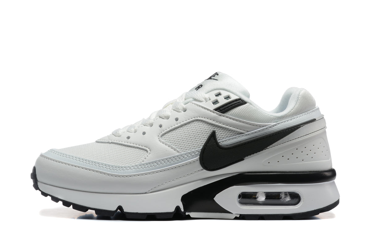 Side view of a white and black Nike low-top sneaker with a visible heel air unit