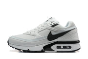 Side view of a white and black Nike low-top sneaker with a visible heel air unit