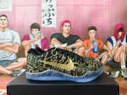 Side view showing the gold side logo and patterned black and gold upper