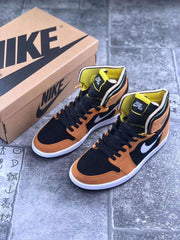 Pair of orange, black, white, and yellow high-top sneakers displayed beside a shoe box.