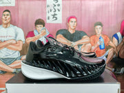 Side view of a black basketball shoe with sculpted detailing and white sole