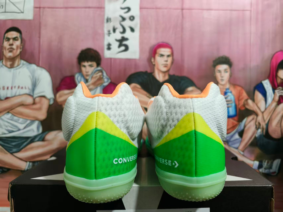 Rear view of white Converse basketball shoes with green heel panels and orange collar accents