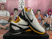 Angled view showing textured uppers, black side logos, and yellow accents