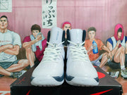 Front view of the white Nike LeBron high-top basketball shoes with navy accents