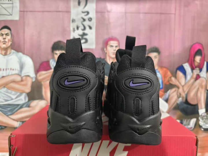 Rear view of black Nike sneakers with purple logos, pull tabs, and a red Nike shoebox.