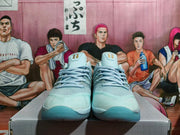 Front view of pale blue Nike basketball shoes with laces and gold tongue details.