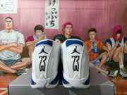Rear view of white sneakers with blue panels and number 23 heel details